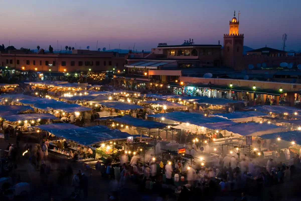 Rows of food stalls on the square at dusk