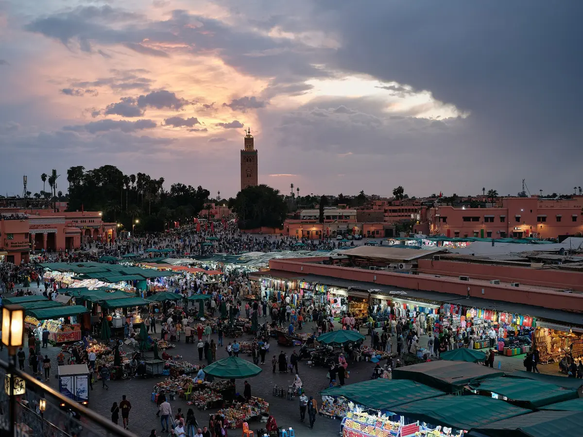 Jemaa el-Fna at sunset with the Koutoubia in the distance